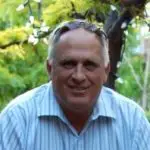 A man with a blue shirt and sunglasses on.
